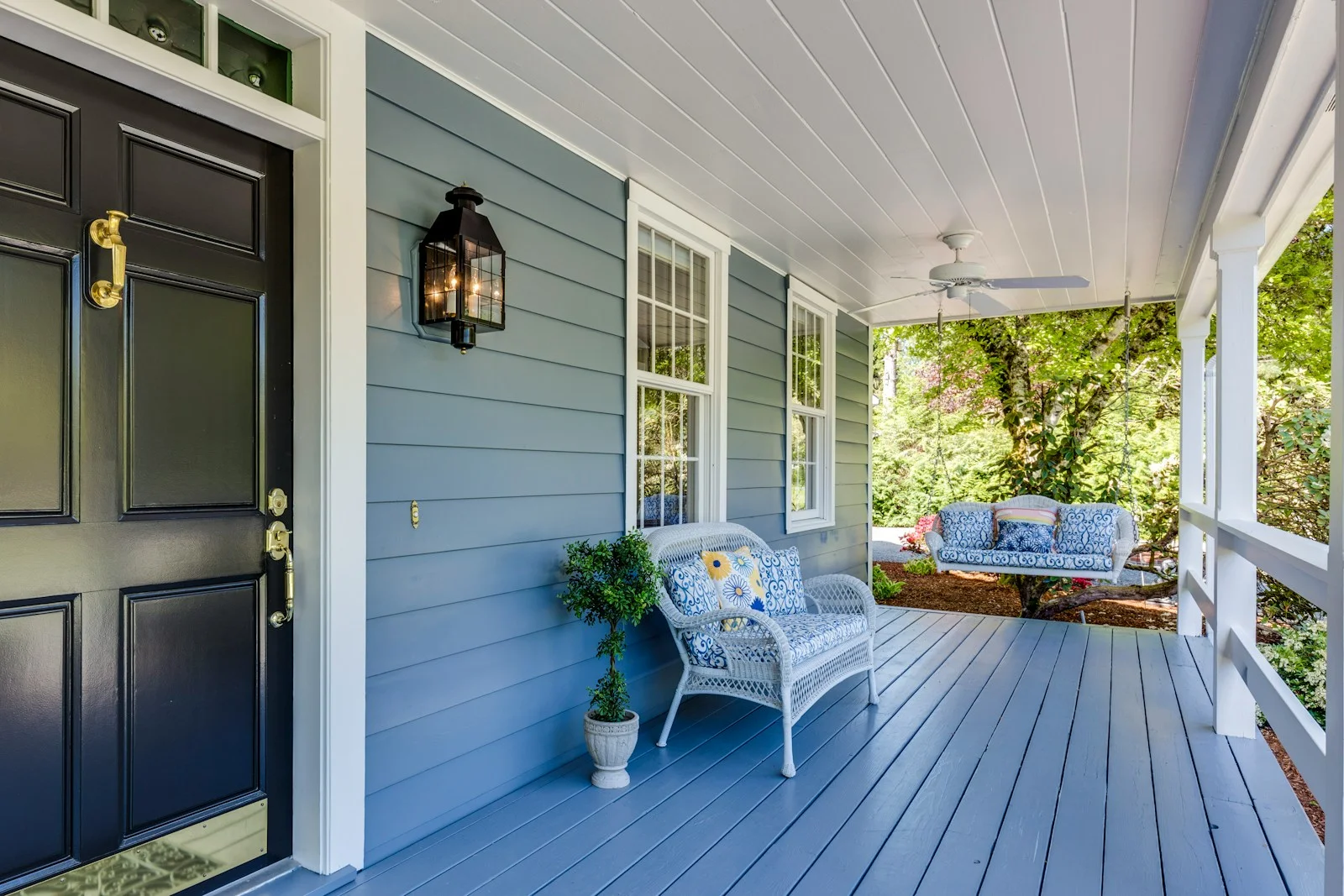 a porch with two chairs and a table on it, broomfield junk removal